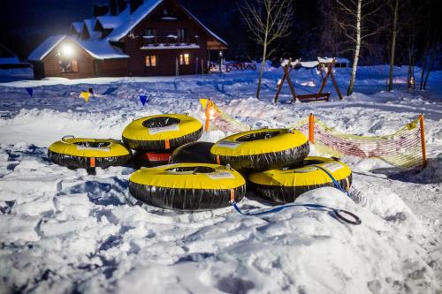 a group of yellow tubes in the snow at Solny - Resort w Bieszczadach in Cisna