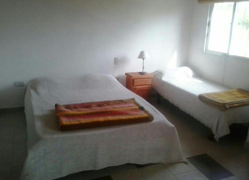 a bedroom with two beds and a window at Apartamentos Atlantida in Colón