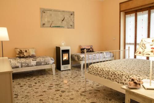 a bedroom with two beds and a fireplace at Villa Claudianna Bed & Bike in Paestum