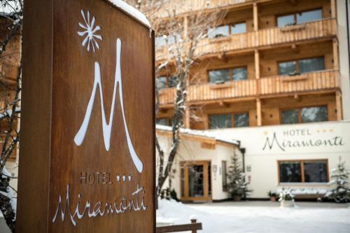 a sign for a hotel in front of a building at Hotel Miramonti Badia in Badia