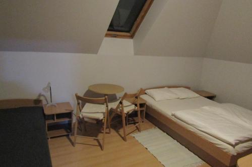 a bedroom with a bed and a table and chairs at Mylak in Korbielów