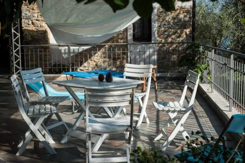 a white table and chairs on a patio at La casa di Elda in Sanremo