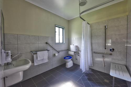 a bathroom with a tub and a toilet and a sink at Daintree Peaks ECO Stays in Daintree