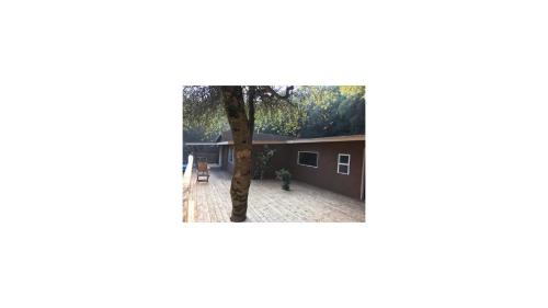 a tree in the courtyard of a house at Mountain Trail Lodge and Vacation Rentals in Oakhurst