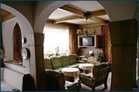 a living room with a couch and a table at Pension Bergfried in Grödig