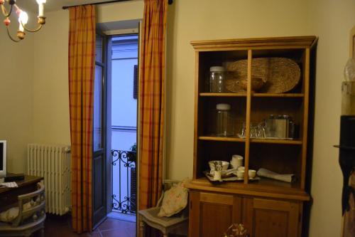 a living room with a book shelf and a door at Albergo Residence Perosi in Tortona
