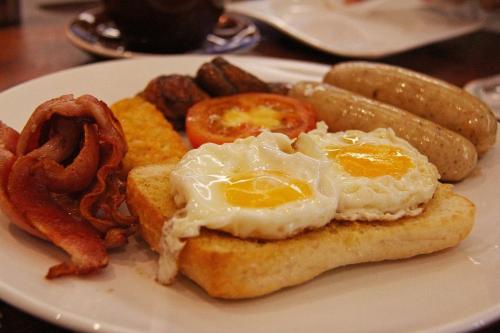 a plate of breakfast food with eggs and bacon at Berizka in Perechin