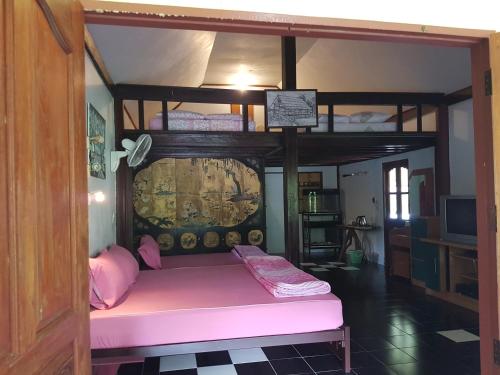 a room with a bunk bed with a pink mattress at Ban Sabai Sabai Guest House in Kanchanaburi