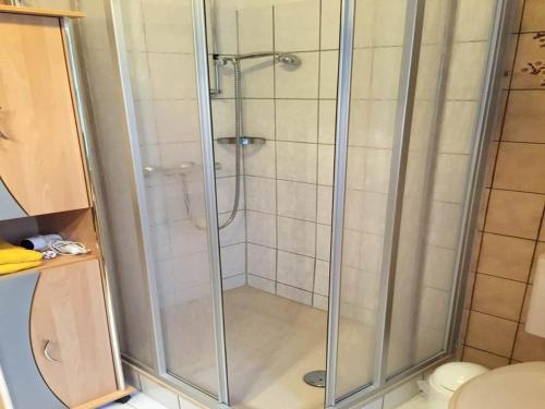 a shower with a glass door in a bathroom at Hotel Carlsruh in Braunlage