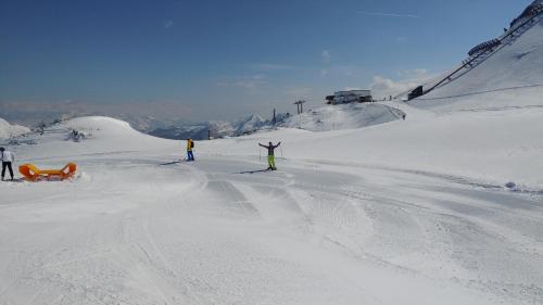 a group of people skiing down a snow covered slope at Haus Susanne in Radstadt