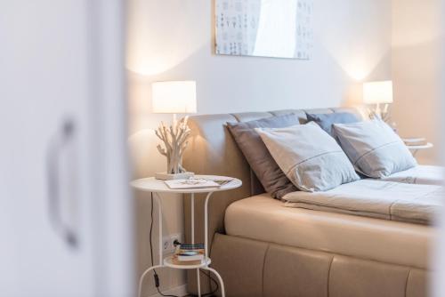 a couch with a side table in a room at Paulay Apartment in Budapest