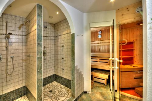a bathroom with a shower and a walk in shower at Hotel Garni Corinna in Ischgl