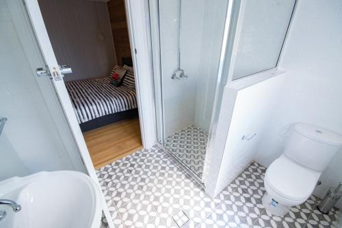 a bathroom with a toilet and a walk in shower at Beautiful Queenslander in Townsville