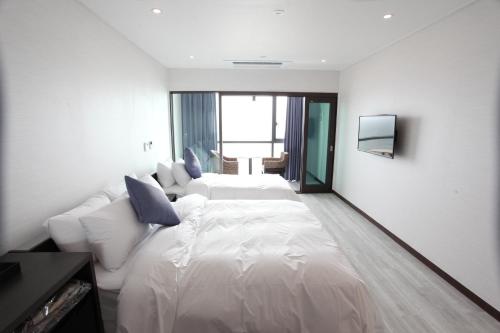 Postelja oz. postelje v sobi nastanitve Hotel Wooyeon Flora