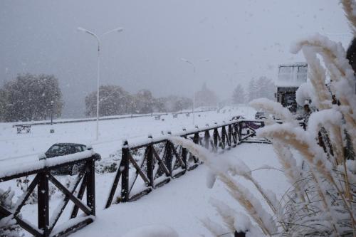 a bridge covered in snow in a snow storm at Hotel Mora in Los Antiguos