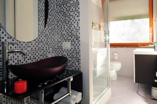 a bathroom with a black sink and a mirror at La Casetta del Vaticano in Rome