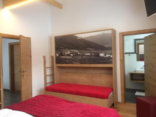 a bedroom with two bunk beds and a mirror at Ferienhaus Wind in Sankt Margarethen im Lungau