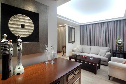 a living room with a couch and a table at Comfy Boutique Hotel in Kalamata