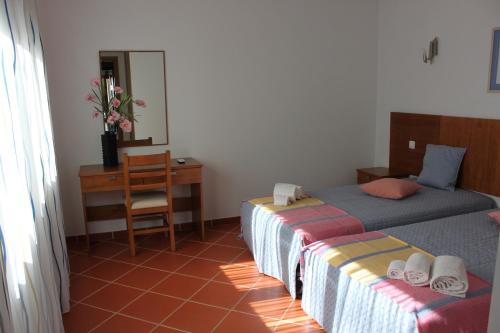เตียงในห้องที่ Apartamentos Colina do Mar Downtown Albufeira