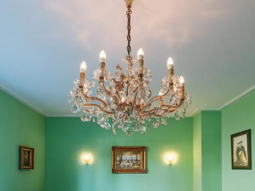 a chandelier hanging from a ceiling in a room at Hotel & Restaurant Raueneck in Bad Saarow