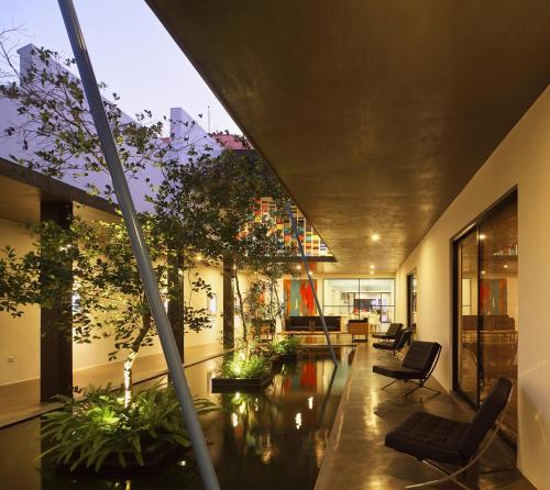 a lobby with chairs and plants in a building at Serendiva Beach in Wadduwa