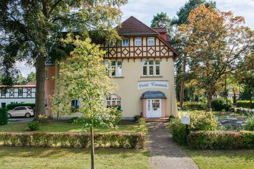 a house with a sign that reads first pharmacy at Hotel & Restaurant Raueneck in Bad Saarow