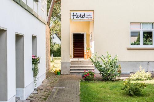 a house with a hotel sign on the door at Hotel & Restaurant Raueneck in Bad Saarow