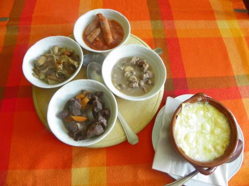 a group of bowls of food on a table at Hotel Les Granges in La Thuile