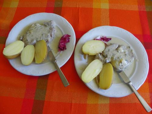 two white plates of food on a table at Hotel Les Granges in La Thuile