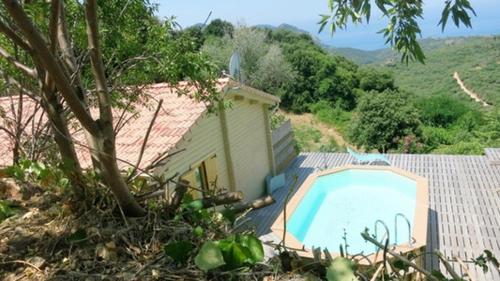 a small swimming pool next to a house at Les Terrasses de Scaglioli in Villanova