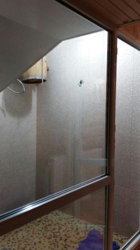 a glass window of a shower in a bathroom at Karpatska Mria in Yaremche