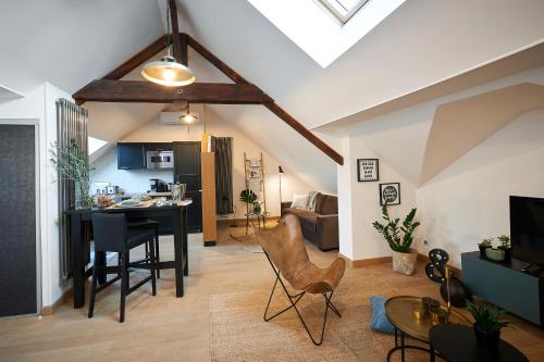 a living room with a dining table and a kitchen at Bubble 8 in Épernay