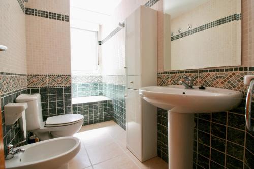 a bathroom with a sink and a toilet at OLIVA HOLIDAYS 1 in Oliva