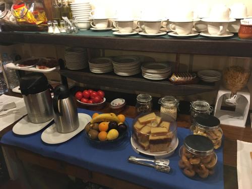 a table topped with plates and bowls of food at Hotel Rural Posada El Trenti de Corona in Valoria