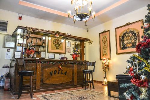 a bar with a christmas tree in a room at Voila Inn in Constanţa