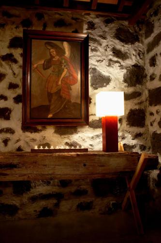 a painting of a woman on a wall with a lamp at Pocinhobay in Madalena
