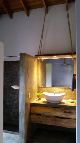 a bathroom with a white sink on a counter at Residencia El Balatà in Las Terrenas
