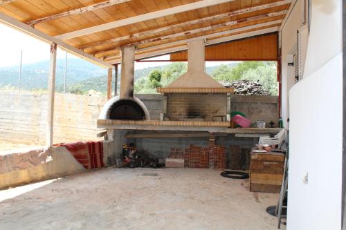 an outdoor kitchen with a stove in a house at Prosilia Guesthouse in Prosília