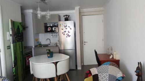 a kitchen with a refrigerator and a table in it at Edificio One in Iquique