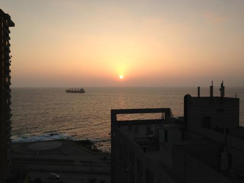 a container ship in the ocean at sunset at ibis Antofagasta in Antofagasta
