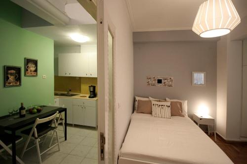 アテネにあるLuxury flat in Kolonaki, 3’ Metroの小さなベッドルーム(ベッド1台付)、キッチンが備わります。