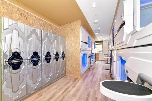 a hockey locker room with a wall of hockeyleys at Space Q Capsule Hotel in Sydney