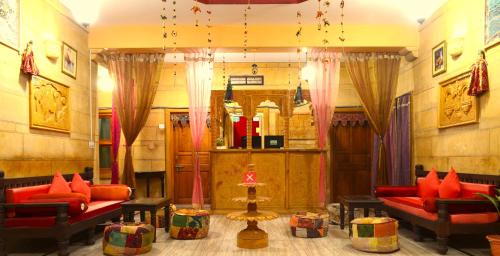 a living room with red couches at Tripli Hotels Prithvi Palace in Jaisalmer