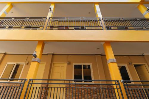 an outside view of a building with balconies at RedDoorz Plus near Palembang Square Mall in Palembang