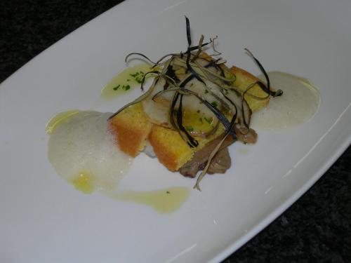 a white plate with a piece of food with sauce at Hotel Gran Mugon in Vigo di Fassa