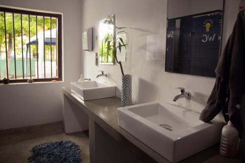 a bathroom with two sinks and a window at Hostel First Mirissa in Mirissa