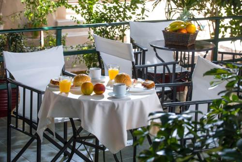a table with fruit and orange juice on a balcony at Golden Sun in Hersonissos