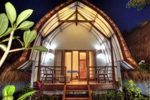 a small house with a large entrance to a room at The Yoga Garden in Gili Trawangan