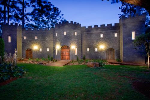 a large castle building with a lawn in front of it at Lisson Grove in Mount Tamborine