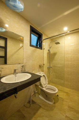 a bathroom with a sink and a toilet and a shower at Hue Homestay Riverside in Hue
